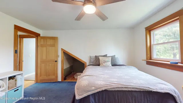 a bedroom with a bed and a window