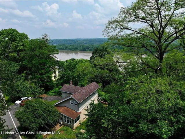 an aerial view of a house with garden space and street view
