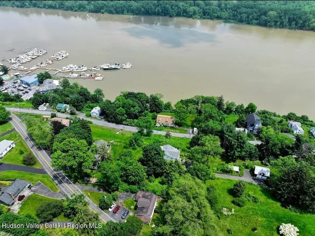 an aerial view of a houses with outdoor space and lake view