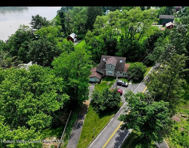 an aerial view of a house with garden space and street view