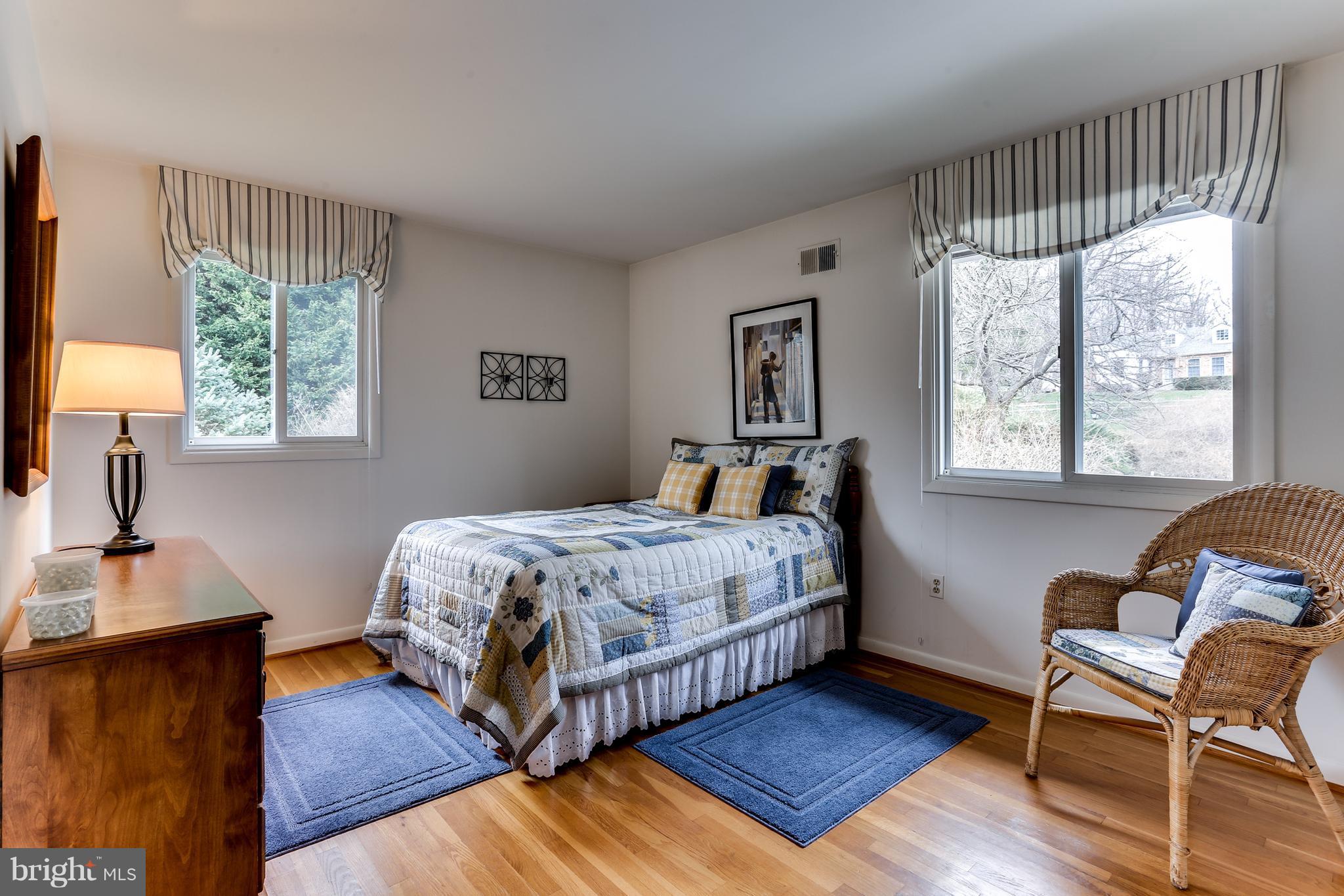 1713 Gamewell Road Silver Spring, MD 20905 - Photo 22 of 30 a bedroom with a bed window and wooden floor