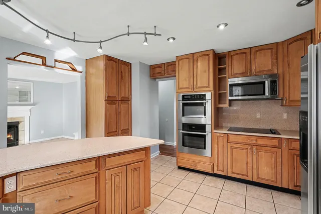 a kitchen with stainless steel appliances a stove sink and refrigerator