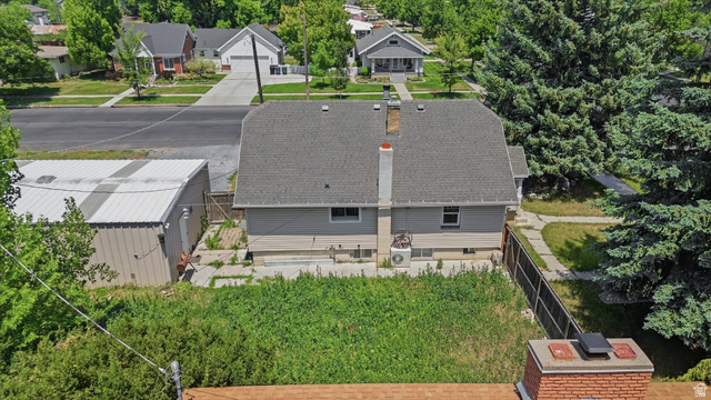 395 North 400 West Logan, UT 84321 - Photo 45 of 48 Gable roofline with asphalt shingles and a central brick chimney