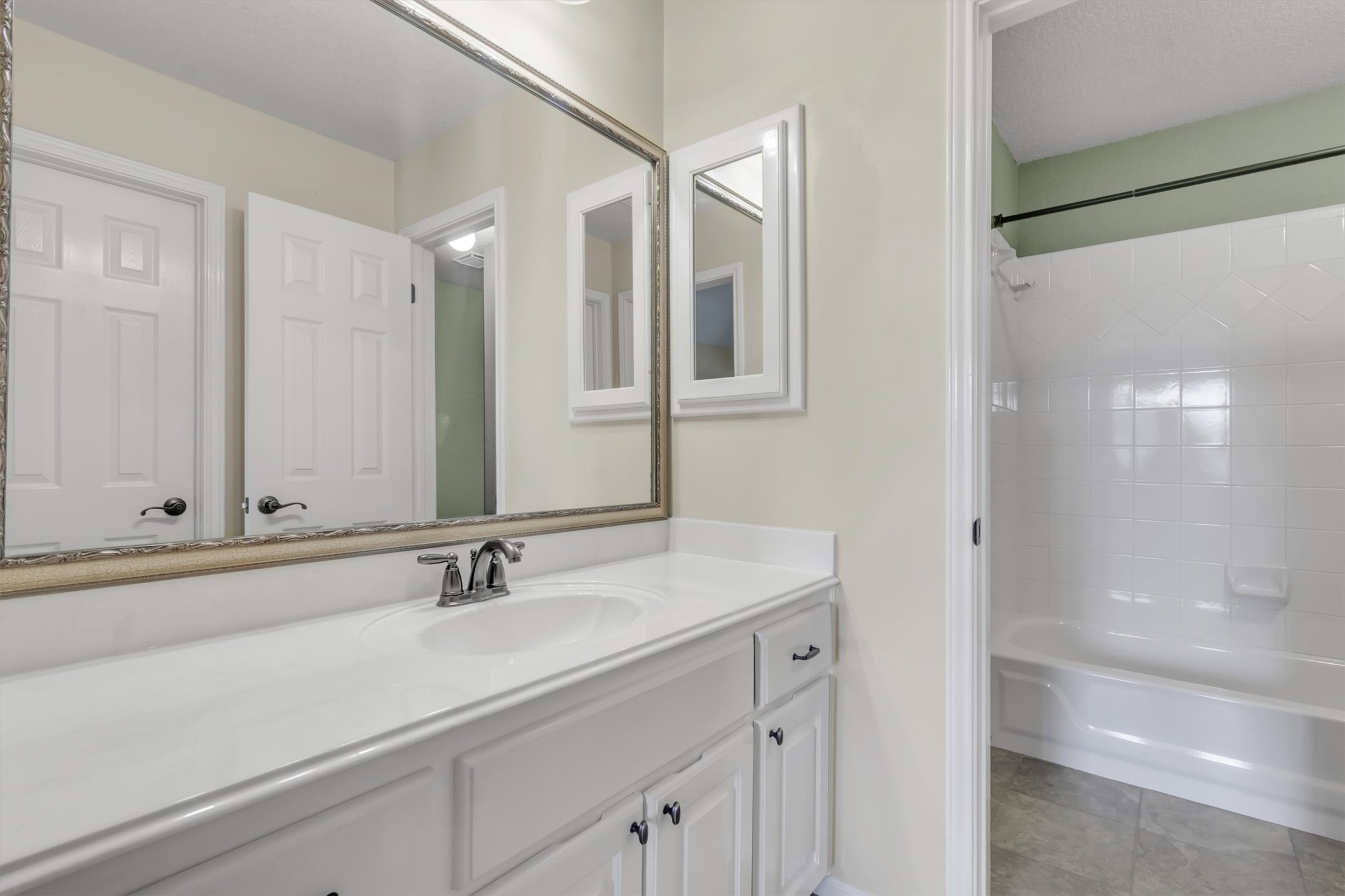 6008 Tributary Ridge Court Austin, TX 78759 - Photo 26 of 36 A full vanity with ample counter space and a classic tub-shower.