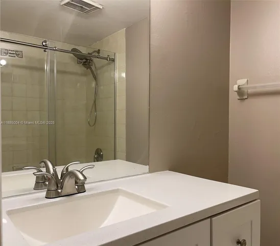 a kitchen with stainless steel appliances white cabinets and a stove
