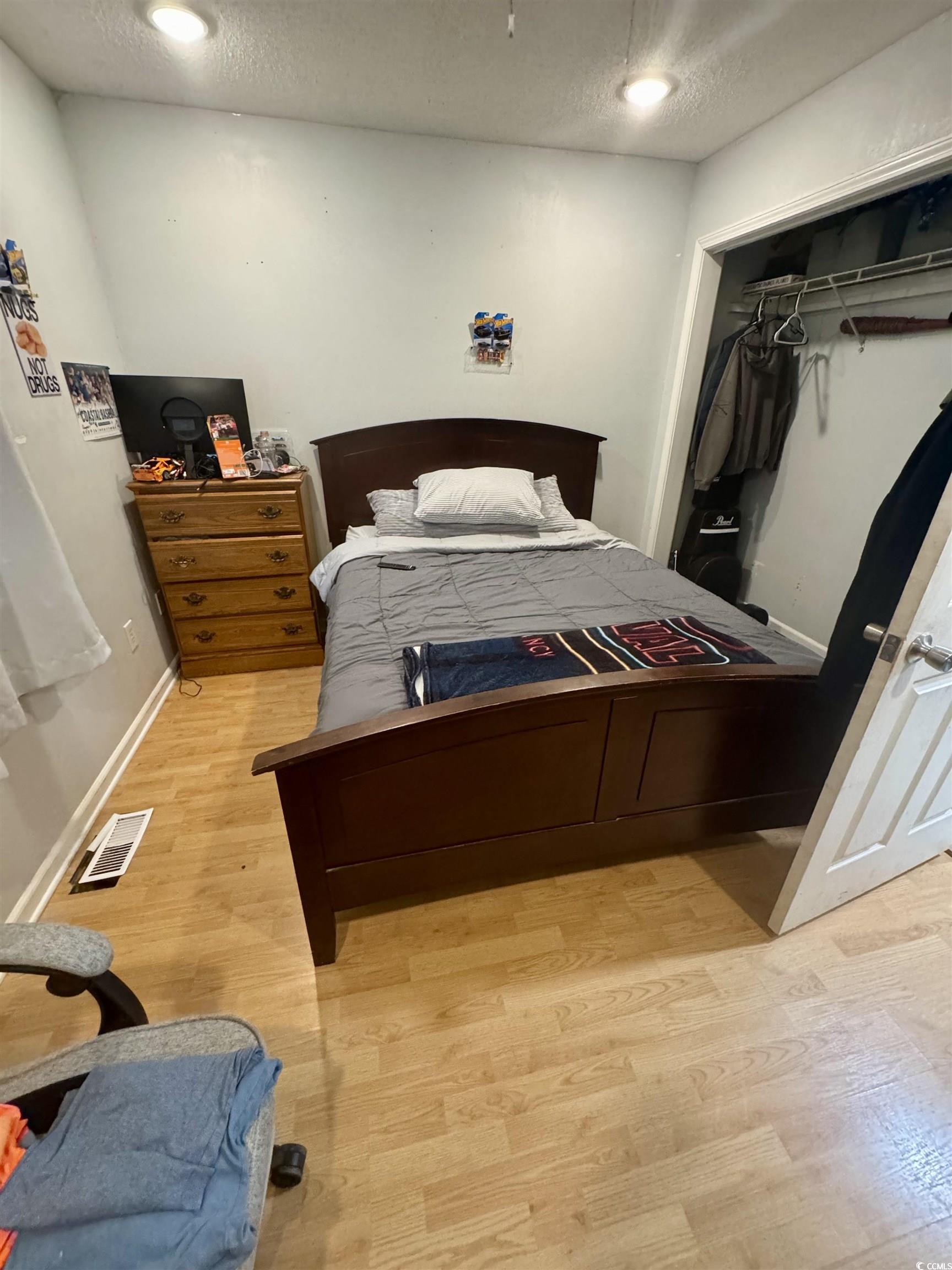 1207 Pinegrove Drive, Unit C Myrtle Beach, SC 29577 - Photo 11 of 16 Bedroom featuring a textured ceiling, a closet, light wood finished floors, and recessed lighting