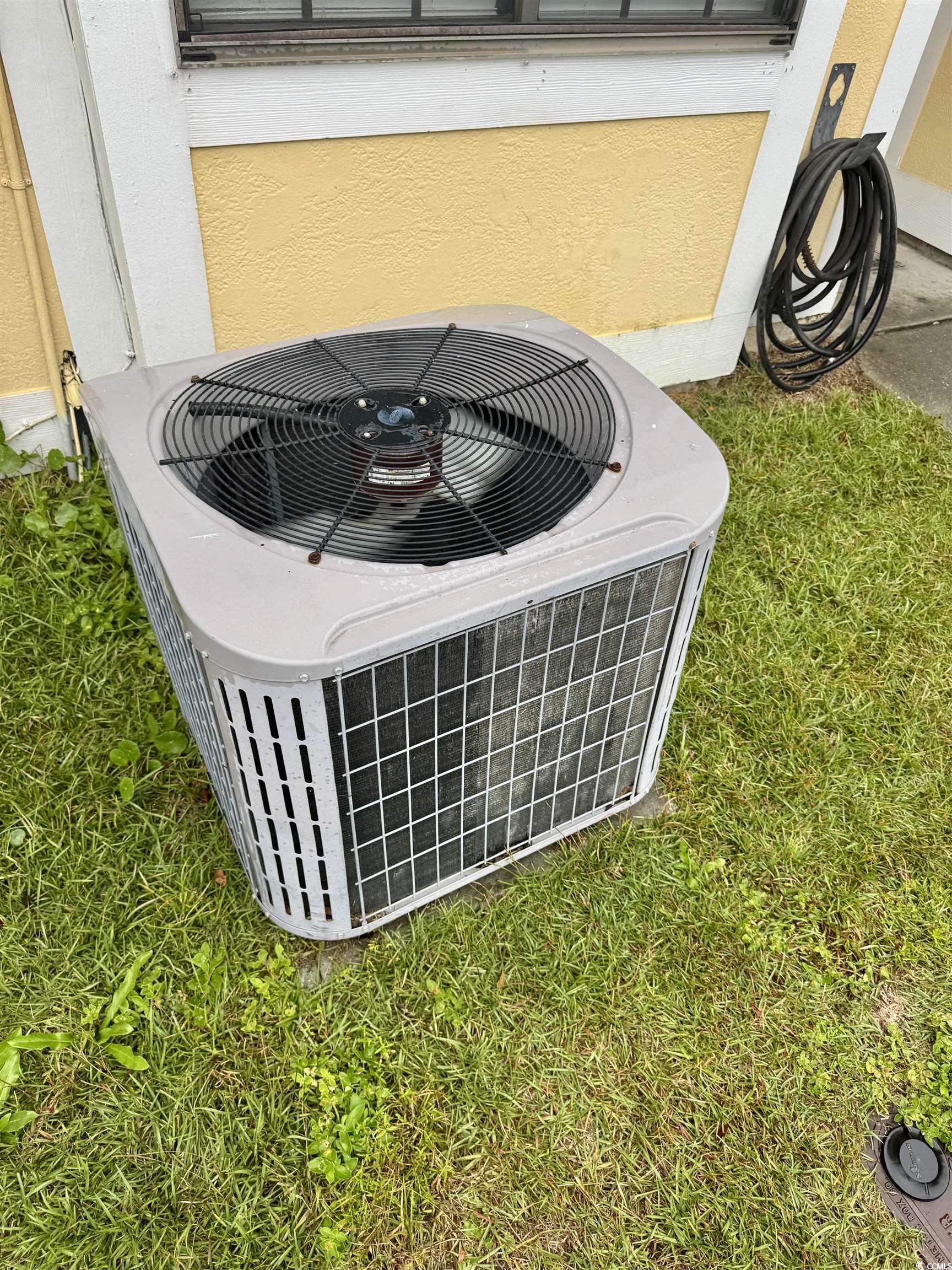 1207 Pinegrove Drive, Unit C Myrtle Beach, SC 29577 - Photo 12 of 16 Exterior view of a cooling unit and stucco siding