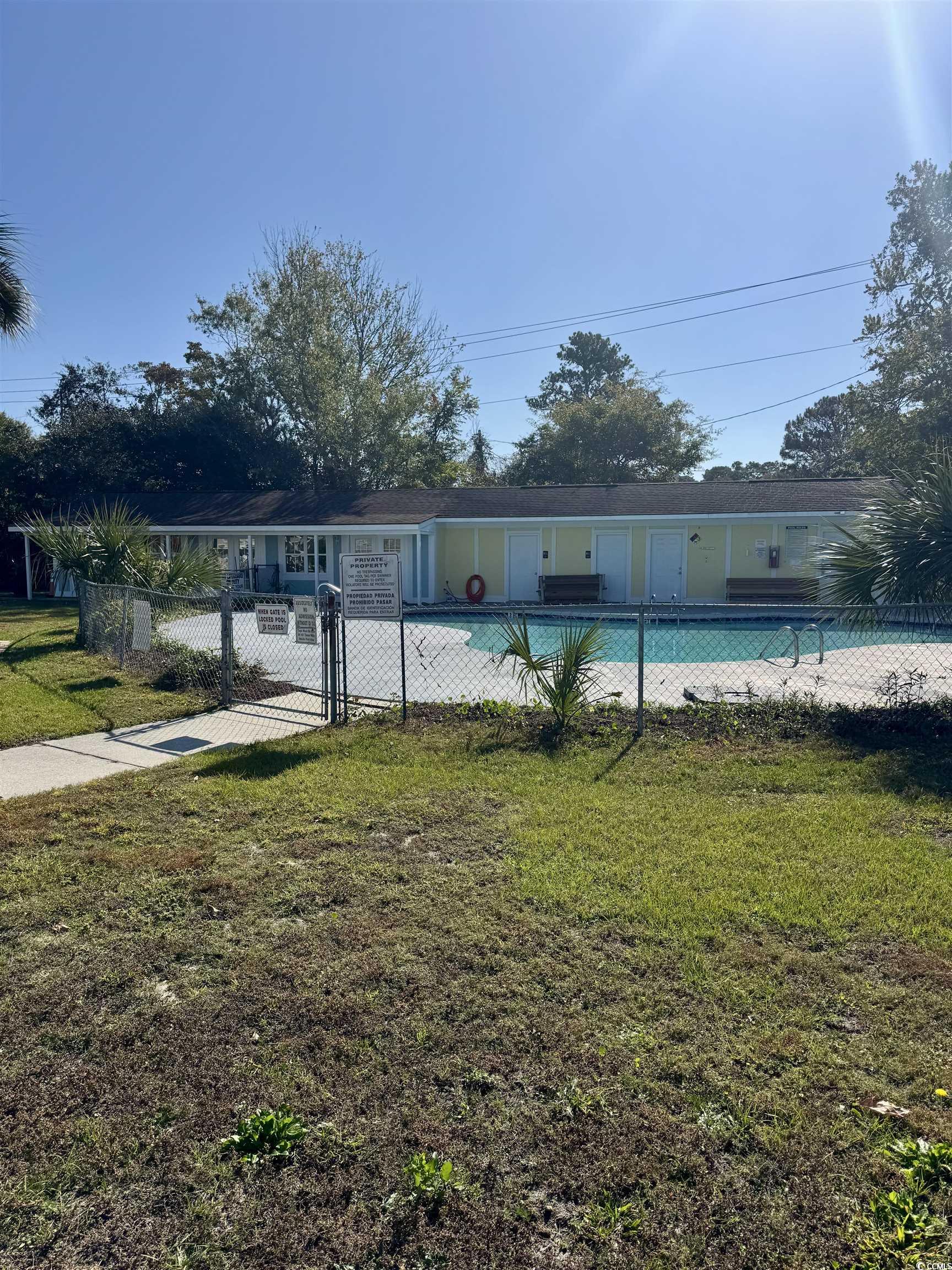 1207 Pinegrove Drive, Unit C Myrtle Beach, SC 29577 - Photo 14 of 16 Community pool featuring a gate
