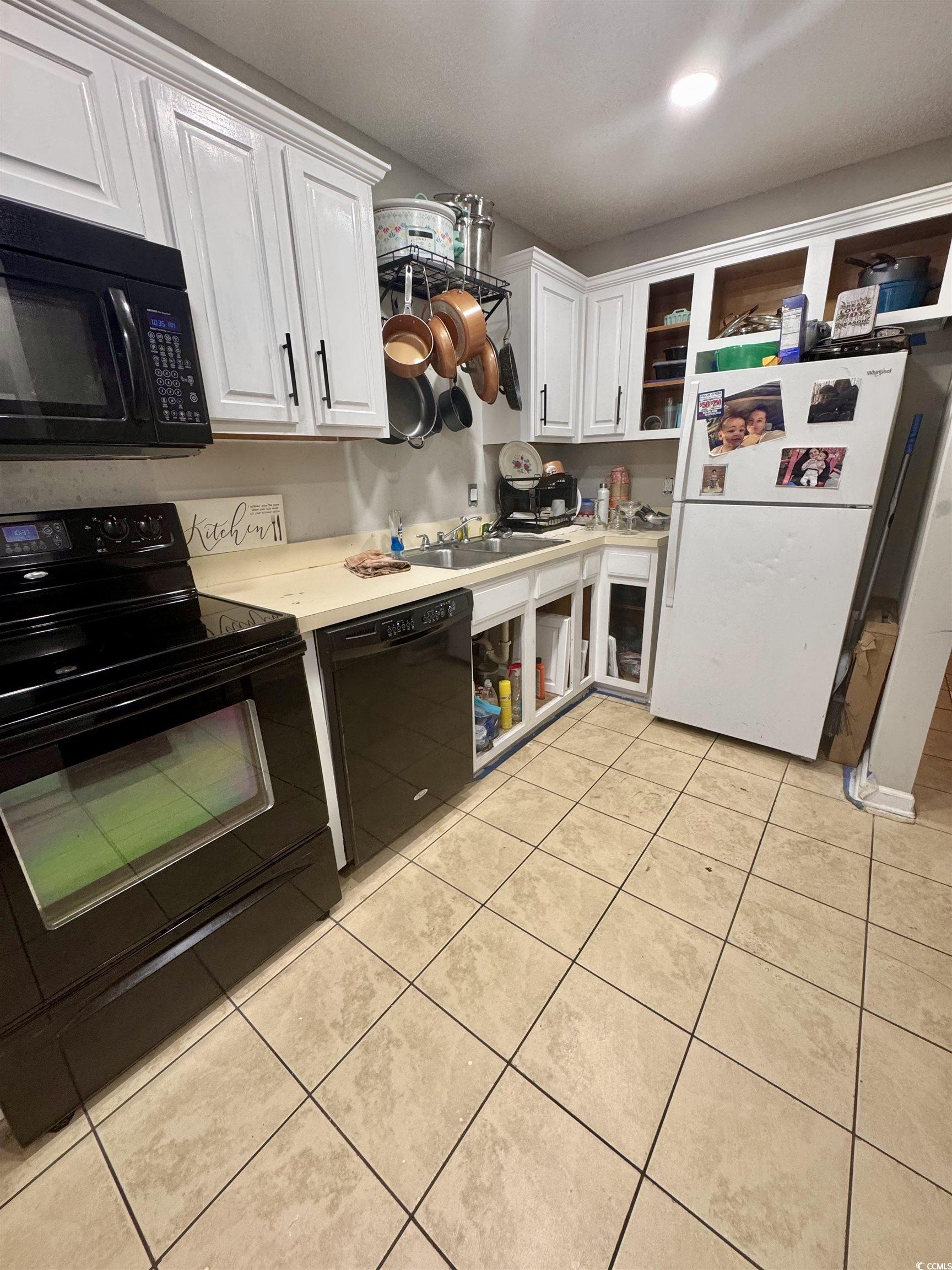 1207 Pinegrove Drive, Unit C Myrtle Beach, SC 29577 - Photo 2 of 16 Kitchen with black appliances, white cabinets, light countertops, open shelves, and light tile patterned floors