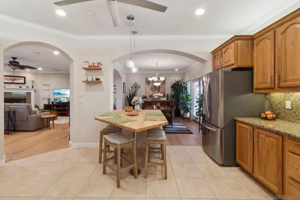 a kitchen with stainless steel appliances kitchen island granite countertop a refrigerator and a stove