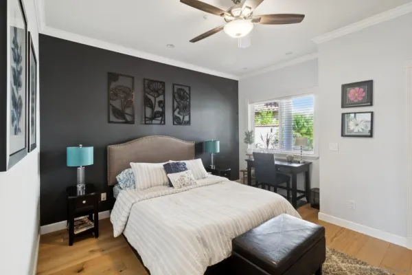 a bedroom with a bed and a chandelier