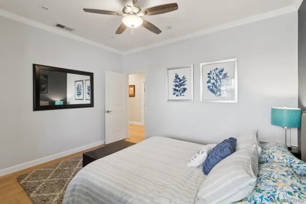 a bedroom with bed and wooden floor