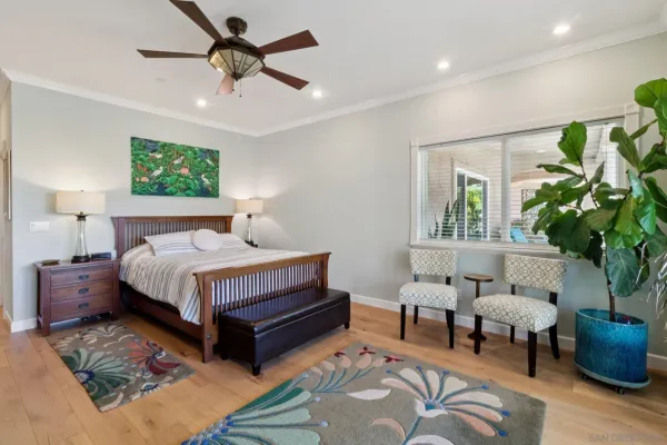 a spacious bedroom with a bed and a potted plant