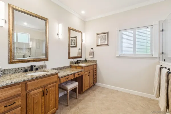 a spacious bathroom with a granite countertop sink a mirror and a