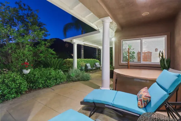 a view of a house with backyard sitting area and garden