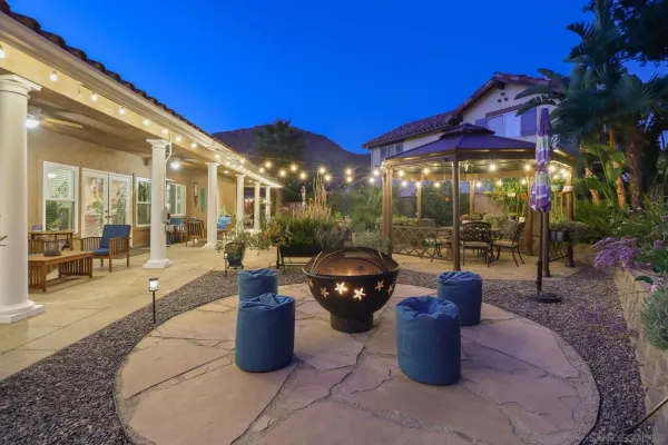 a view of a patio with dining table and chairs