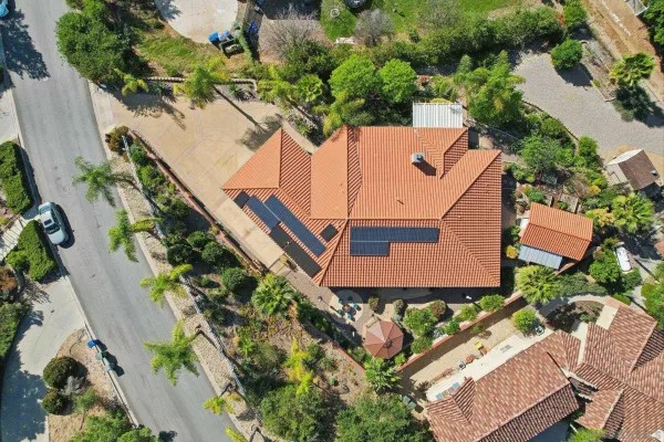 an aerial view of a house with a yard and potted plants