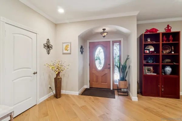 a view of an entryway with wooden floor