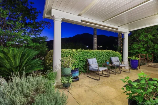 a view of patio with table and chairs and potted plants