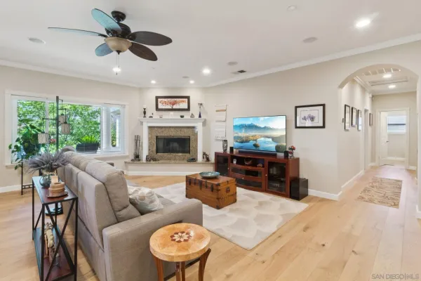 a living room with furniture a fireplace and a flat screen tv