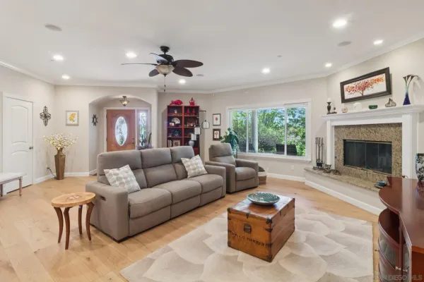 a living room with furniture a fireplace and a flat screen tv