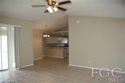 8374 Robin Road Fort Myers, FL 33967 - Photo 3 of 7 a room with a chandelier fan and kitchen view
