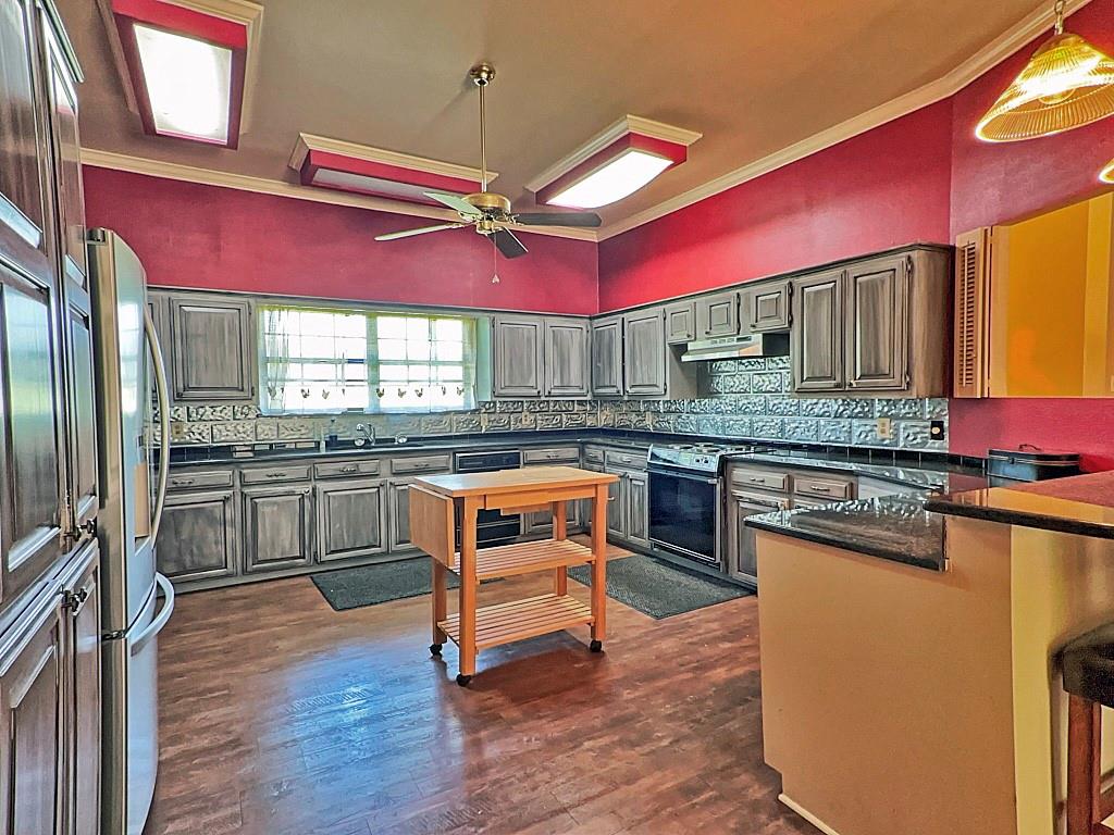 10466 Fm 3273 Athens, TX 75751 - Photo 3 of 24 a kitchen with stainless steel appliances granite countertop wooden cabinets and a stove top oven