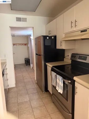 a kitchen with a stove and a refrigerator