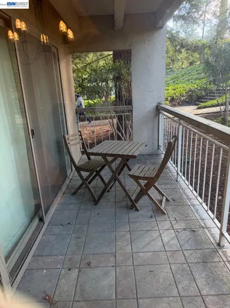 a view of a chairs and table in the balcony