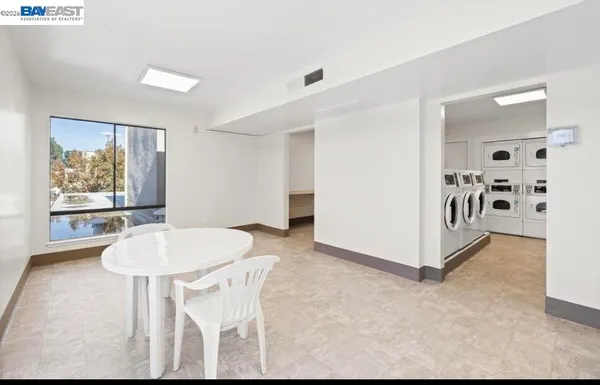 a dining room with furniture and window