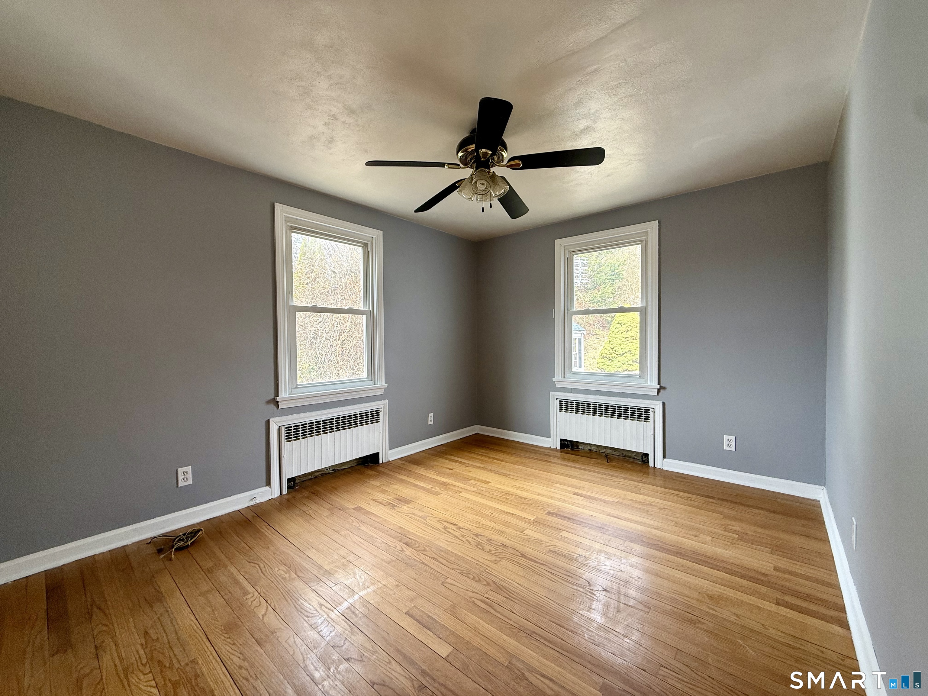 37 Alexander Avenue, Unit 1 Waterbury, CT 06705 - Photo 11 of 14 a view of empty room with wooden floor and fan