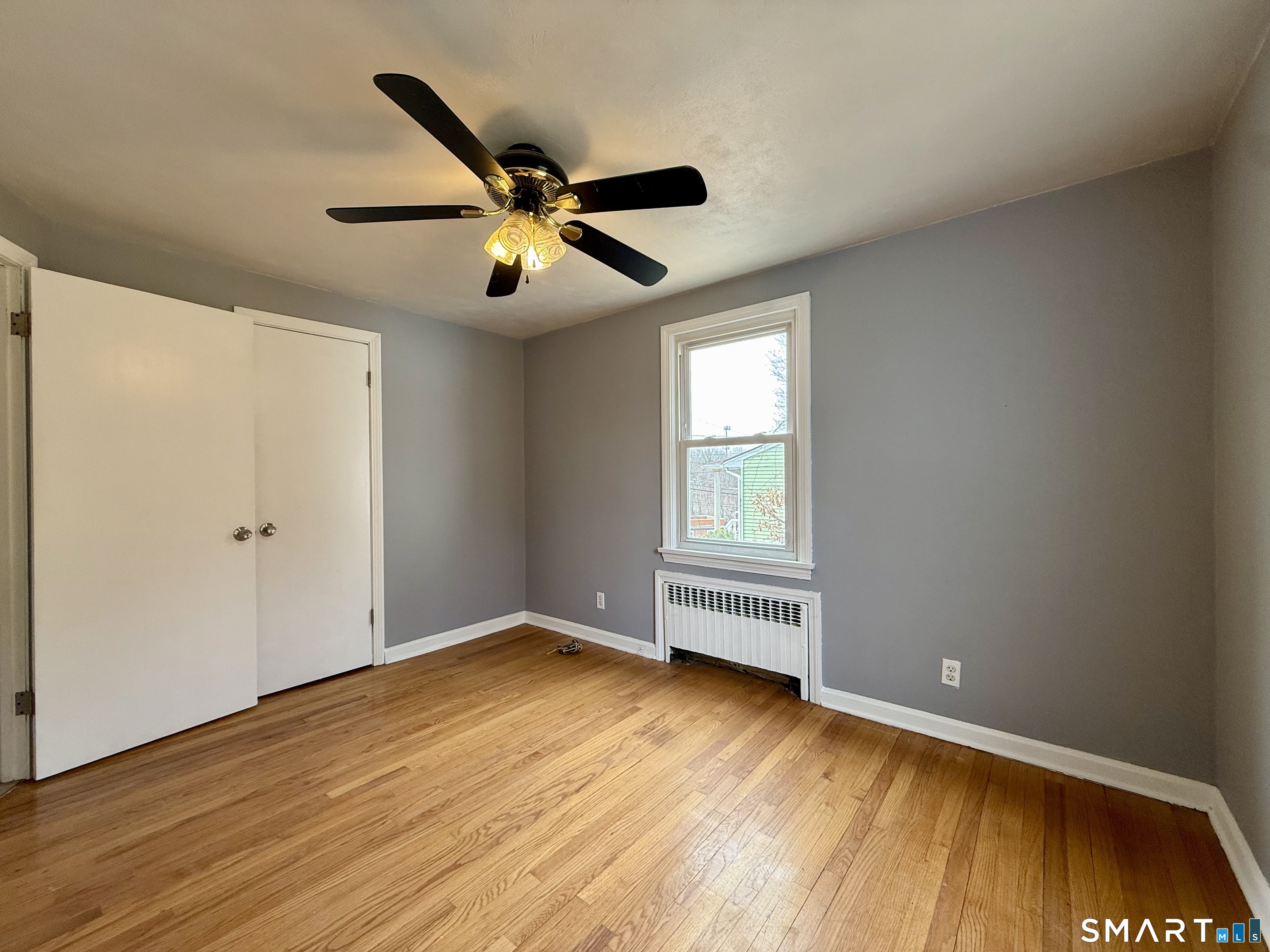 37 Alexander Avenue, Unit 1 Waterbury, CT 06705 - Photo 12 of 14 a view of an empty room with wooden floor and a window
