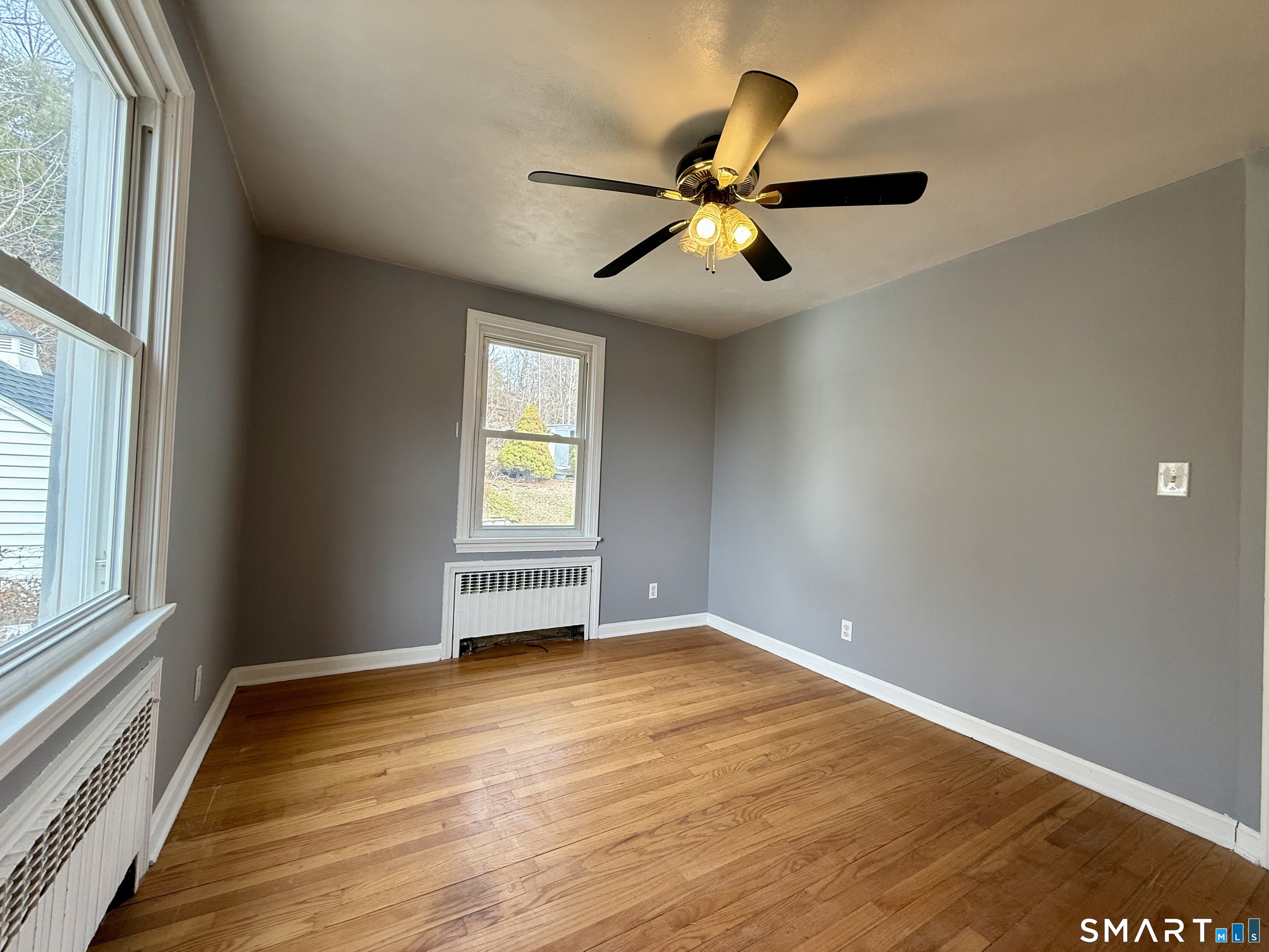 37 Alexander Avenue, Unit 1 Waterbury, CT 06705 - Photo 13 of 14 a view of an empty room with wooden floor and a window