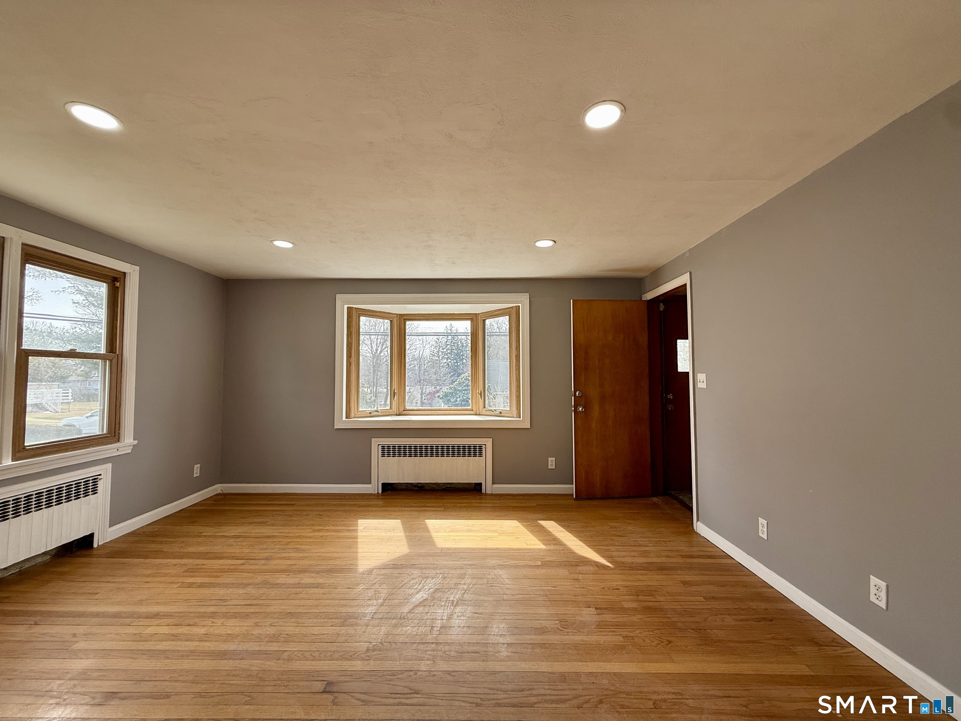 37 Alexander Avenue, Unit 1 Waterbury, CT 06705 - Photo 3 of 14 an empty room with a window and wooden floor