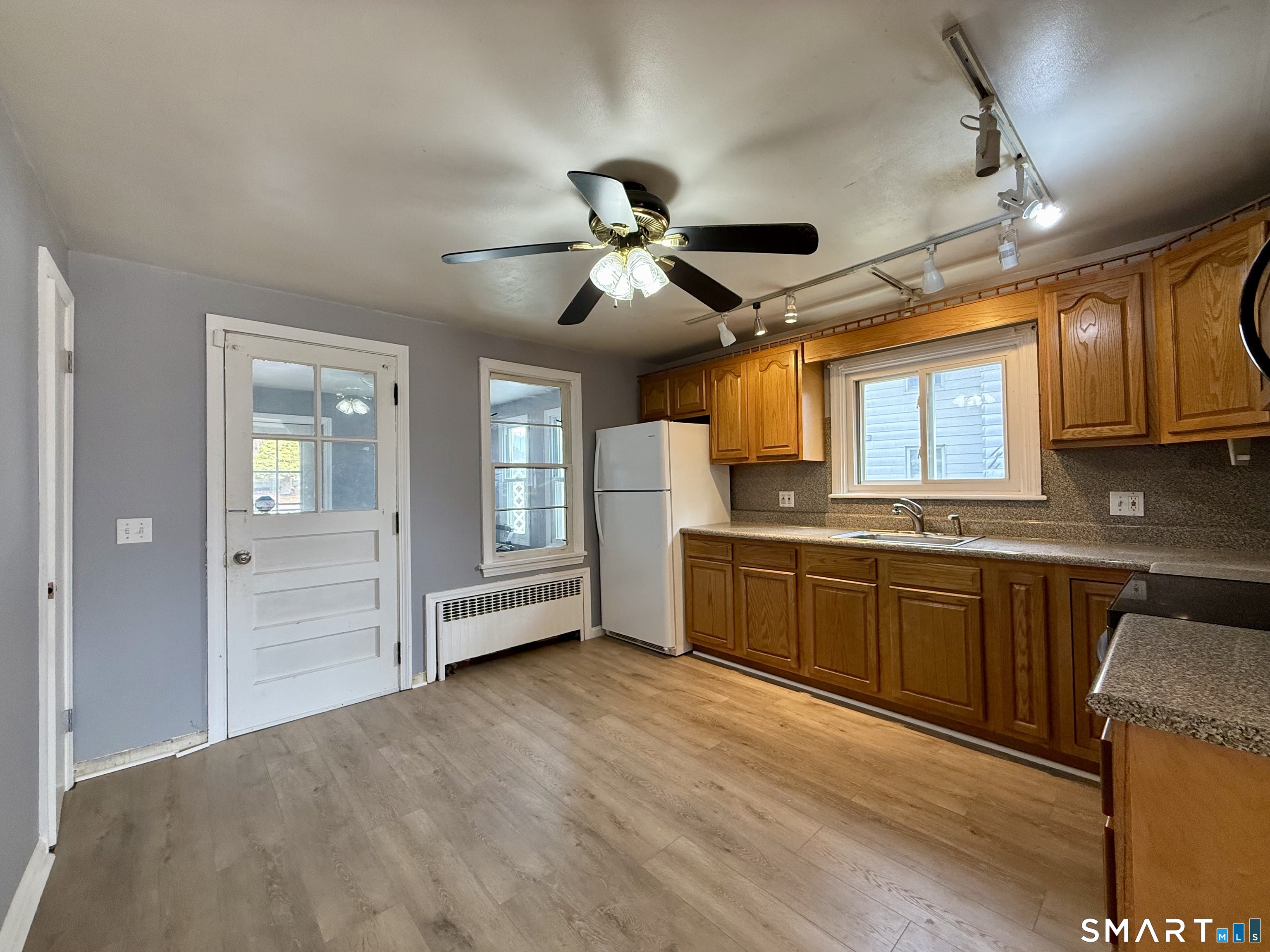 37 Alexander Avenue, Unit 1 Waterbury, CT 06705 - Photo 4 of 14 a kitchen with granite countertop a sink cabinets stainless steel appliances and a window