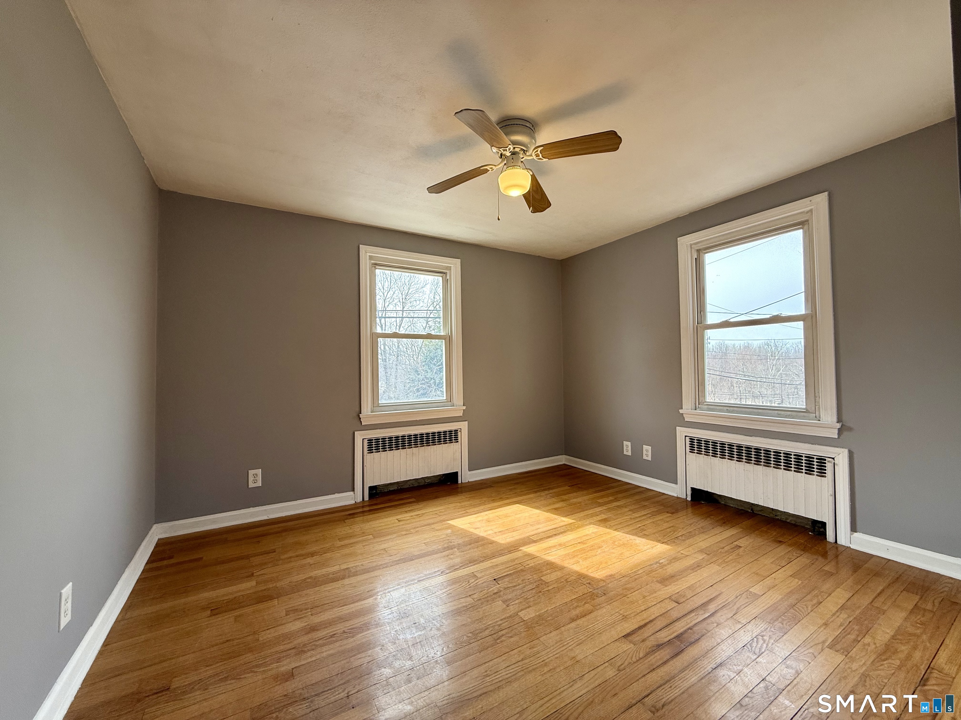 37 Alexander Avenue, Unit 1 Waterbury, CT 06705 - Photo 7 of 14 a view of an empty room with a window and wooden floor