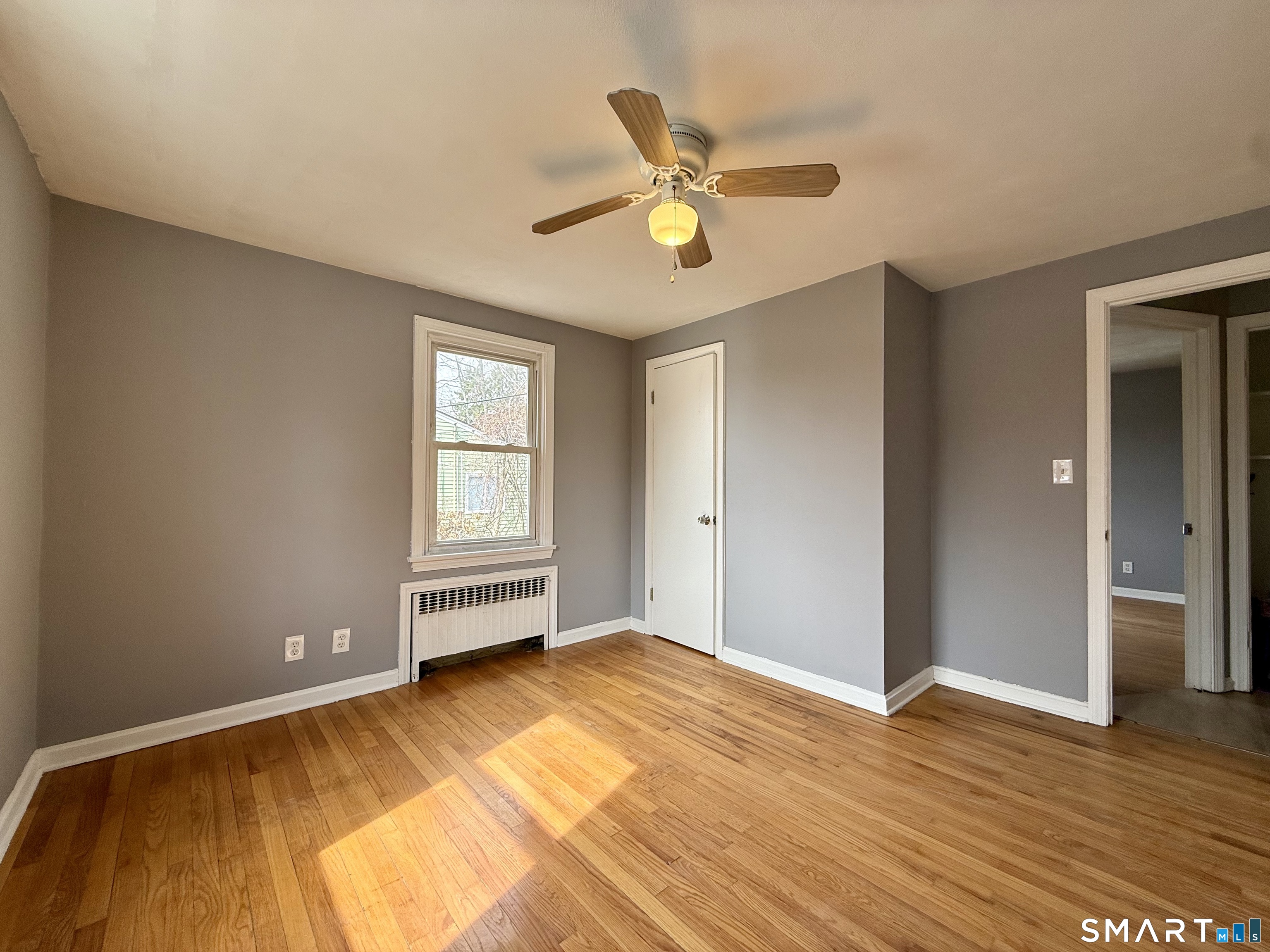 37 Alexander Avenue, Unit 1 Waterbury, CT 06705 - Photo 8 of 14 a view of an empty room with wooden floor and a window