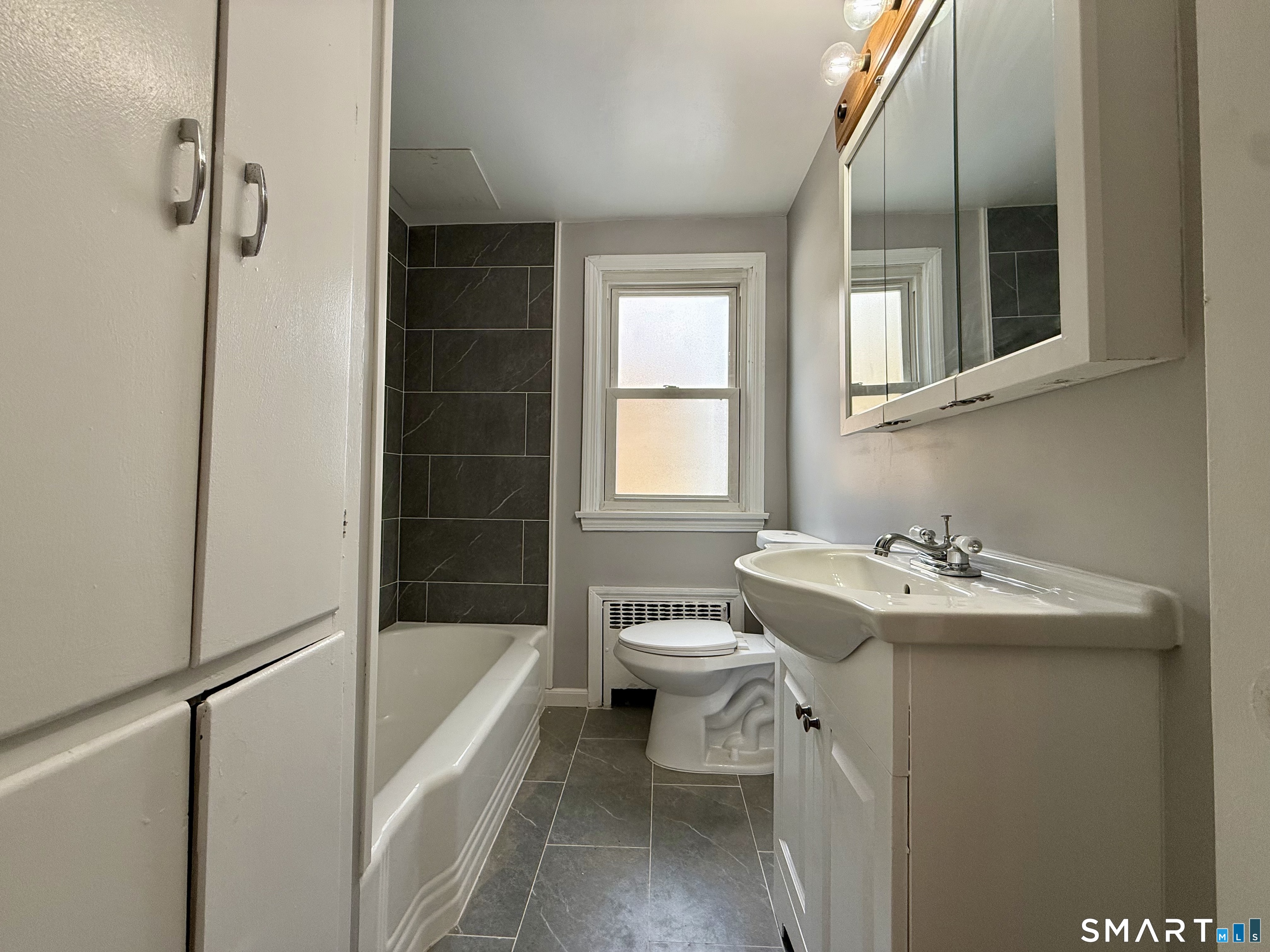 37 Alexander Avenue, Unit 1 Waterbury, CT 06705 - Photo 9 of 14 a bathroom with a sink toilet and shower
