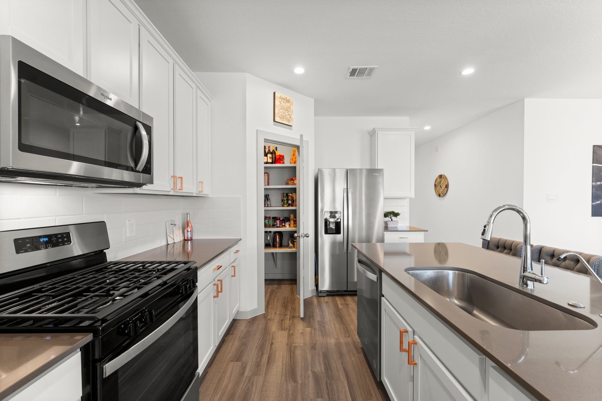 1007 Cotswold Court Rosharon, TX 77583 - Photo 11 of 30 a kitchen with stainless steel appliances a sink a stove and a microwave