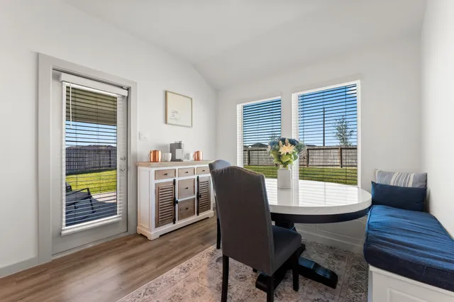 a dining room with furniture and window