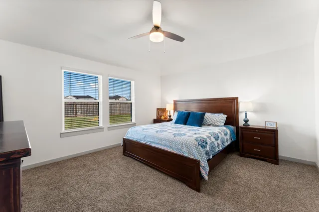 a spacious bedroom with a bed and a window