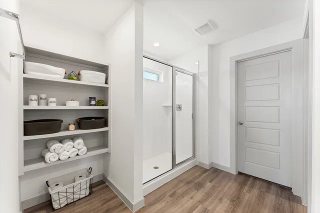 a view of room with shelf and wooden floor
