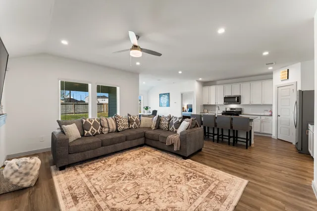 a living room with furniture and wooden floor