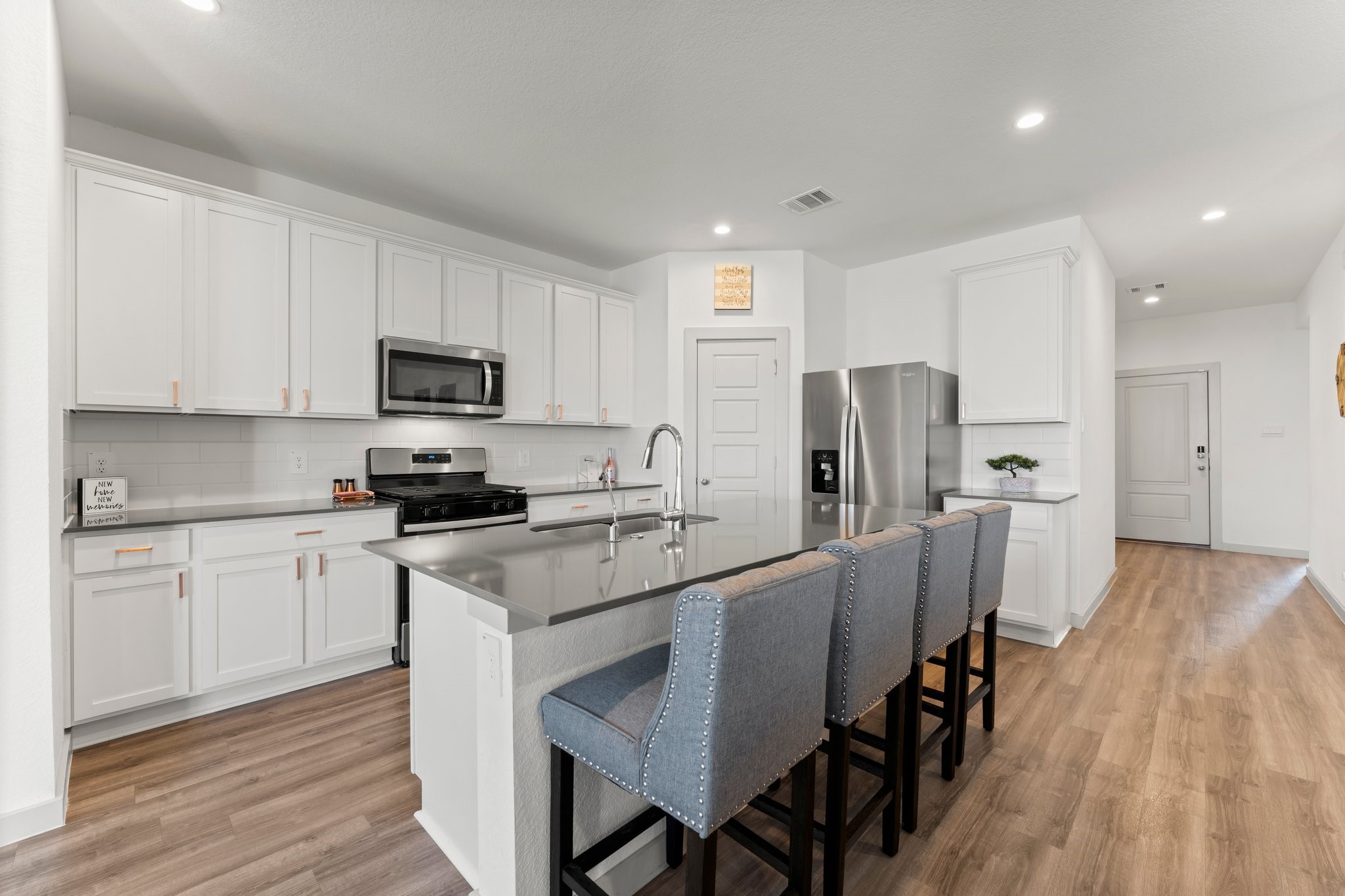 1007 Cotswold Court Rosharon, TX 77583 - Photo 10 of 30 a kitchen with stainless steel appliances a stove a sink refrigerator and a microwave
