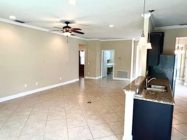 a view of a kitchen with a sink and living room view