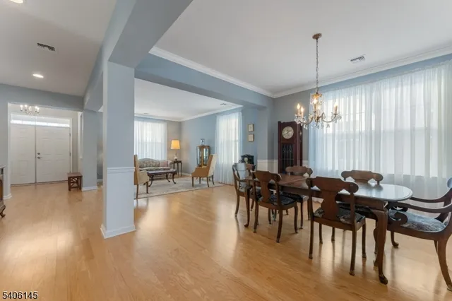 a view of a a dining room with furniture window and wooden floor