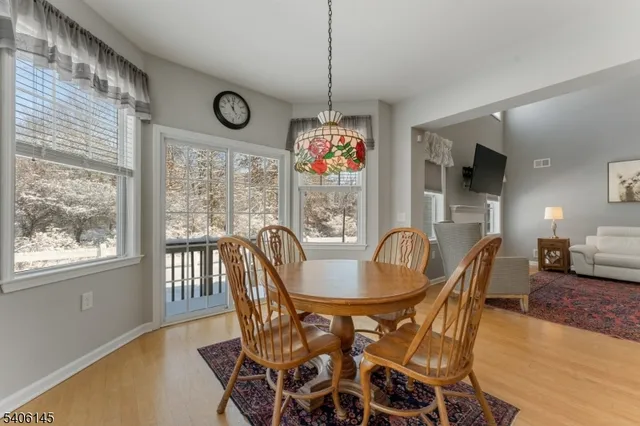 a dining room with furniture wooden floor and a chandelier