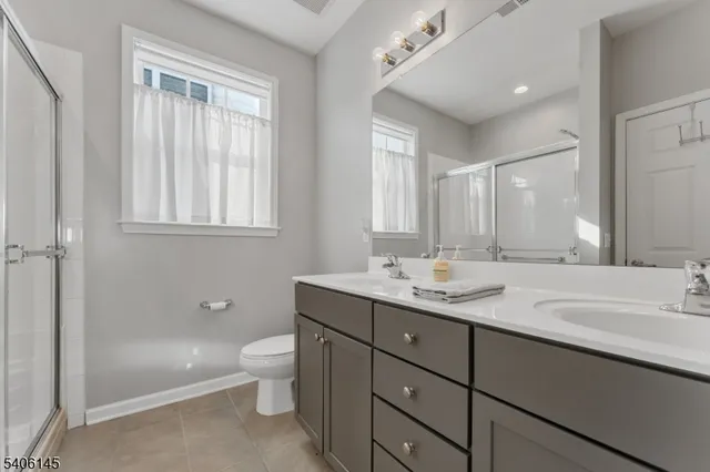 a bathroom with a granite countertop sink a toilet and a bathtub
