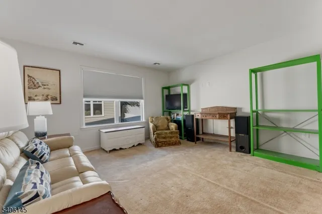 a bedroom with furniture and a lamp