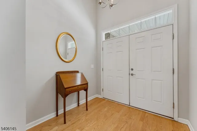 a view of a room with wooden floor and white walls
